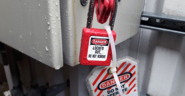Image of a lockout tag in use with a lock on an electrical box